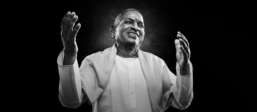 Ilaiyaraaja on stage with both hands raised